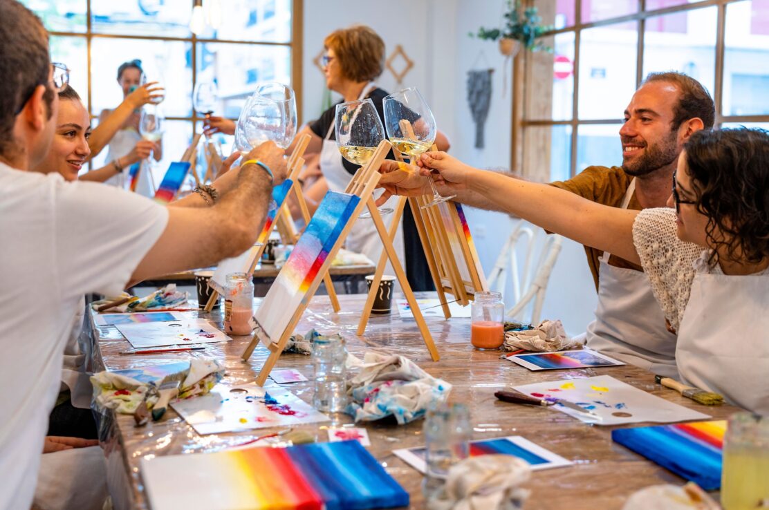 A group of people attending a painting workshop.