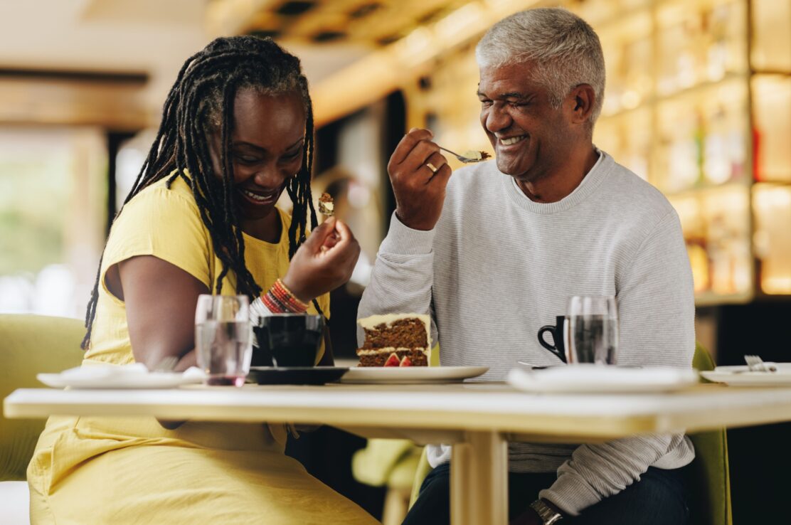 A couple laughing together at a café.